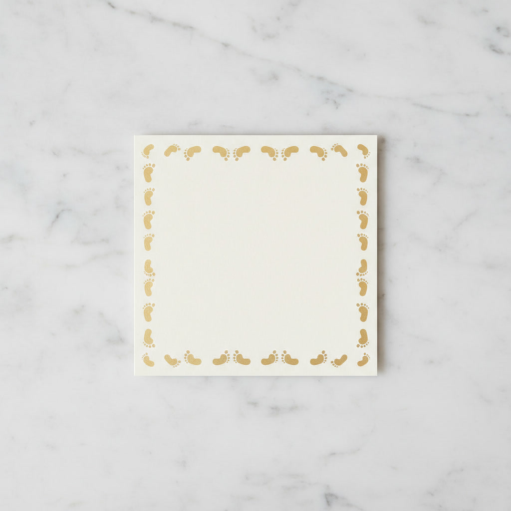 AI pregnancy announcement generator example — a cream announcement card on marble with a gold baby footprint border and an empty centre panel