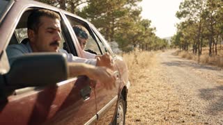 A realistic cinematic shot of a quiet forest road in Turkey on a very hot summer afternoon, pine trees, dry grass near the roadside, warm sunlight, a parked family car near the edge of the road, peaceful but fragile nature atmosphere, slow cinematic push-in, documentary public service announcement style, vertical 9:16, no text, no logo, no watermark, no fire, no smoke.

Realistic cinematic public service announcement short film, hot summer day in Turkey, forest road and dry grass near pine trees, a parked car on the roadside, an adult in the car almost throws a cigarette butt out of the window, a child or teenager in the back seat notices and silently warns the adult, the adult realizes the danger, safely puts out the cigarette butt in a small metal container or car ashtray, calm but serious atmosphere, natural acting, warm sunlight, dry summer landscape, documentary realism, shallow depth of field, soft film grain, vertical 9:16, no text, no logo, no watermark, no cartoon, no animation, no fire.

Genel Negatif Prompt: wildfire, flames, burning forest, disaster scene, smoke cloud, panic, injured animals, dead animals, blood, violence, crying child, scary scene, destroyed houses, war, explosion, cartoon, animation, 3D, exaggerated acting, text, logo, watermark, distorted hands, extra fingers, deformed faces, unrealistic movement.
