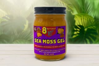 Create a premium final hero shot using the exact uploaded Sea Moss Gel product. Place the jar prominently in the center of the frame on a clean natural surface. Tropical leaves and subtle Caribbean-inspired elements in the background. Camera slowly moves toward the product. Beautiful cinematic lighting. Product label remains exactly as provided and fully readable. Do not modify, redesign, or replace the packaging. End with the product centered and clearly visible. No people.