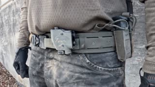 Use the uploaded image as a locked reference frame.
Do not redesign, regenerate, or alter any equipment.

The following must remain exactly identical to the image:

Stacato belt-mounted PTT unit

belt, pouch, cables, and routing

operator clothing, gloves, pants, shirt

all equipment placement and proportions

No new equipment. No modification. No reinterpretation.

Scene:
A desert wadi canyon at dusk, rocky ground and sandstone walls similar to Negev terrain. Lighting is soft late-evening light with long shadows.

Action:
The operator walks slowly forward for one second along the wadi floor.

Camera:
Close waist-level tracking shot.
The camera stays locked on the belt area and PTT.
Very shallow camera movement following the operator.

Framing:
Torso and belt only.
PTT is the visual center of the frame.

Motion:
Natural walking motion only.
Very slight cable movement and fabric motion from walking.

Constraints:

Do not change the headset, weapon, belt, pouch, or clothing

No new objects

No redesign of hardware

Treat the image as real hardware captured on video

Style:
Ultra-realistic Tier-1 operator documentary footage.
Natural dust, desert atmosphere, subdued cinematic lighting.

Duration: ~1 second