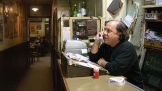 El encargado del bar atiende el telefono y habla y dice en español, argentino: "Hable!", las personas de la mesa del fondo toman un café. 35mm. shallow depth of field realistic motion blur subtle film grain soft bloom
ray traced reflections in a cinematic scene with professional lighting, shallow depth of field, and movie-quality visual effects