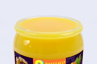 Slow cinematic close-up of the actual Sea Moss Gel jar. Show the texture of the gel being scooped with a spoon. Make the gel look fresh, smooth, and appetizing.