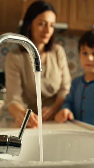 Close-up of the child’s hand gently turning off the running tap. The water stops. The adult notices and looks at the child with a soft expression of realization and appreciation. Natural realistic acting, warm family home atmosphere, cinematic close-up, no exaggerated emotion, hopeful and thoughtful mood, vertical 9:16, no text, no logo, no watermark.

Realistic cinematic public service announcement short film about saving water at home, a warm Turkish family home, kitchen or bathroom sink, an adult accidentally leaves the tap running while distracted, a child notices the running water and quietly turns off the tap, the adult sees this and realizes the importance of saving water, calm emotional storytelling, natural acting, warm daylight, documentary realism, shallow depth of field, soft film grain, vertical 9:16, no text, no logo, no watermark, no cartoon, no animation.

Genel Negatif Prompt: cartoon, animation, 3D, fantasy, disaster, drought disaster, crying child, extreme poverty, dirty water, war, violence, blood, scary atmosphere, exaggerated acting, text, logo, watermark, distorted hands, extra fingers, deformed faces, unrealistic water movement, messy dirty house.