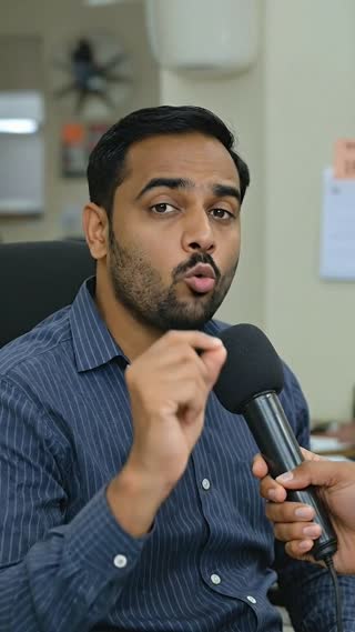 The men looks directly at the camera, speaking in Hindi with minimal, expressive hand gestures, emphasizing his points with an empathetic but unwavering gaze. say few fast
 He says: "तभी दोस्त ने बोला ऊल्का डाउनलोड कर, तू बस हिंदी में बता, वो बैंक से अपने आप इंग्लिश में मेल भेज देगा। AI एक्सपर्ट ने रिपोर्ट देखी पुरानी क्रेडिट कार्ड एंट्री गलत थी।AI ने बैंक को मेल किया, एंट्री ठीक हुई"
