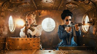 Interior of armored car, all brass with portholes for windows as seen in the reference mage.  The blonde woman   should look exactly as she does in the reference image but the woman with black hair LOOKS A  LITTLE DIFFERENT with her black high piled high in Gibson Girl style, wearing very old-fashioned round wire rimmed dark sunglasses and wearing a blue Edwardian outfit.  Both HAVE THEIR MACHINE RIFLES POINTED OUTSIDE THROUGH THE PORHOLE WINDOWS ON EITHER SIDE OF THEM AND ARE FIRING THE MACHINE RIFLES NOT STRAIGHT AHEAD, THEY ARE FIRING THROUGH THE ROUND WINDWS IN THE CAR in a cinematic scene with professional lighting, shallow depth of field, and movie-quality visual effects in a cinematic scene with professional lighting, shallow depth of field, and movie-quality visual effects